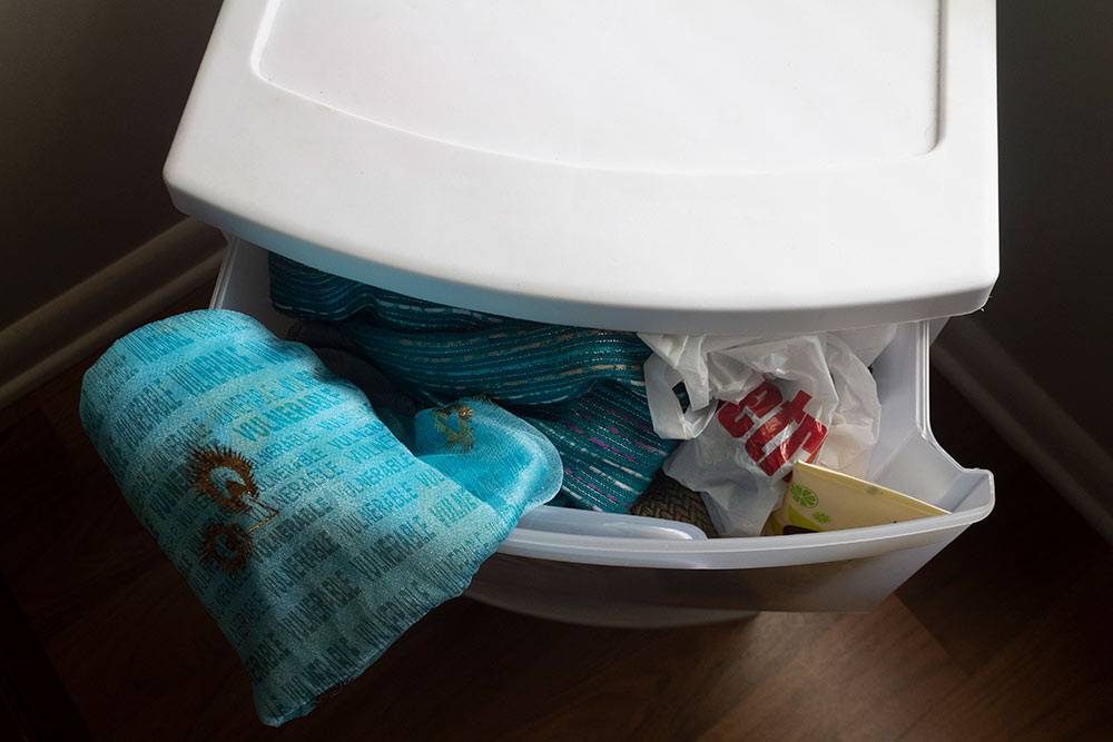 plastic drawers with cloth hanging out that says "vulnerable"