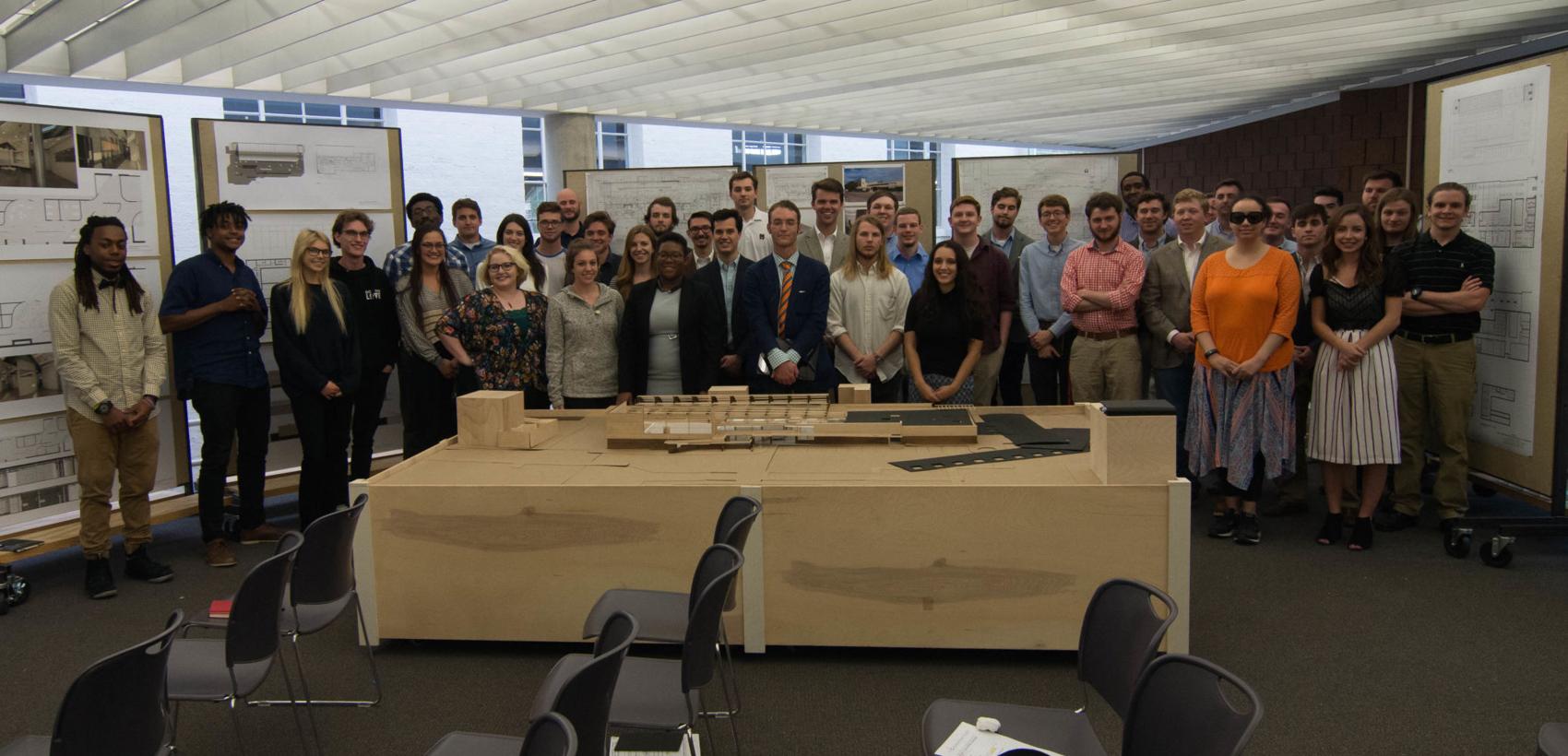 Provided by Mitchel Marshall  Mitchel Marshall, center with orange tie, stands with MSU students following their presentations about the building.