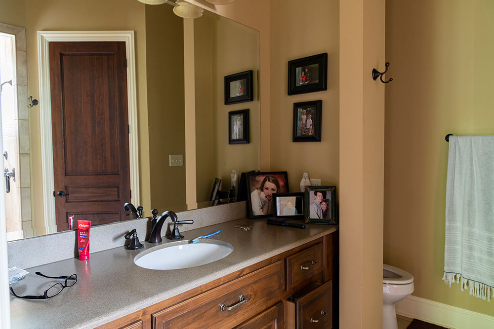 one side of double vanity in bathroom, toilet at far right