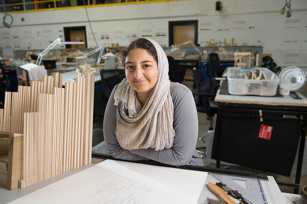 Nada Abdel-Aziz poses at her desk in Giles Hall