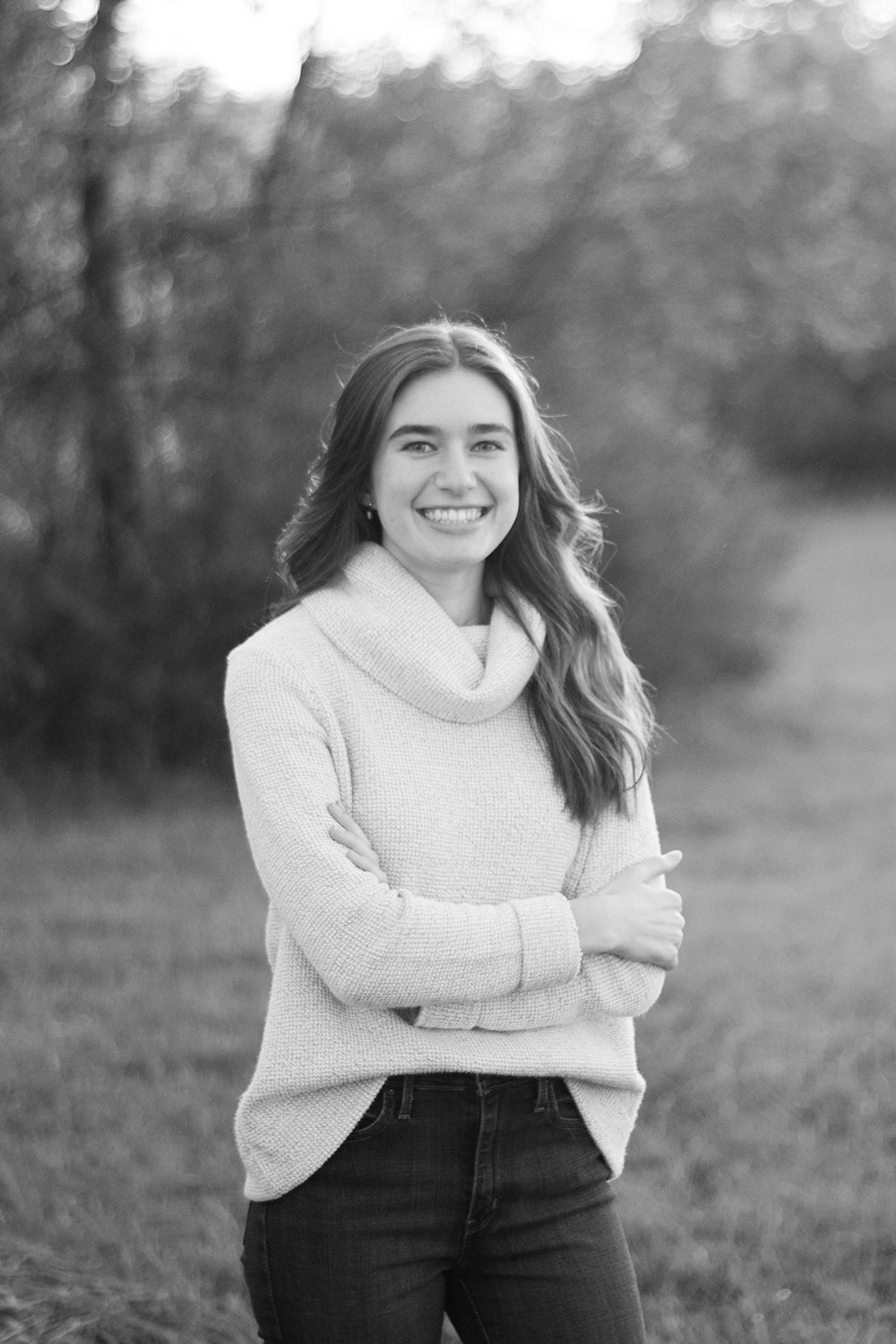 black and white shot of Addison Buntin standing outside with one arm crossed