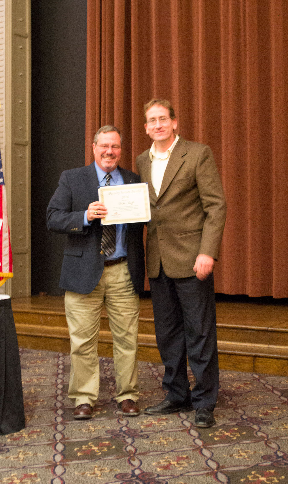 Craig Capano, left, presents award to Mike Duff