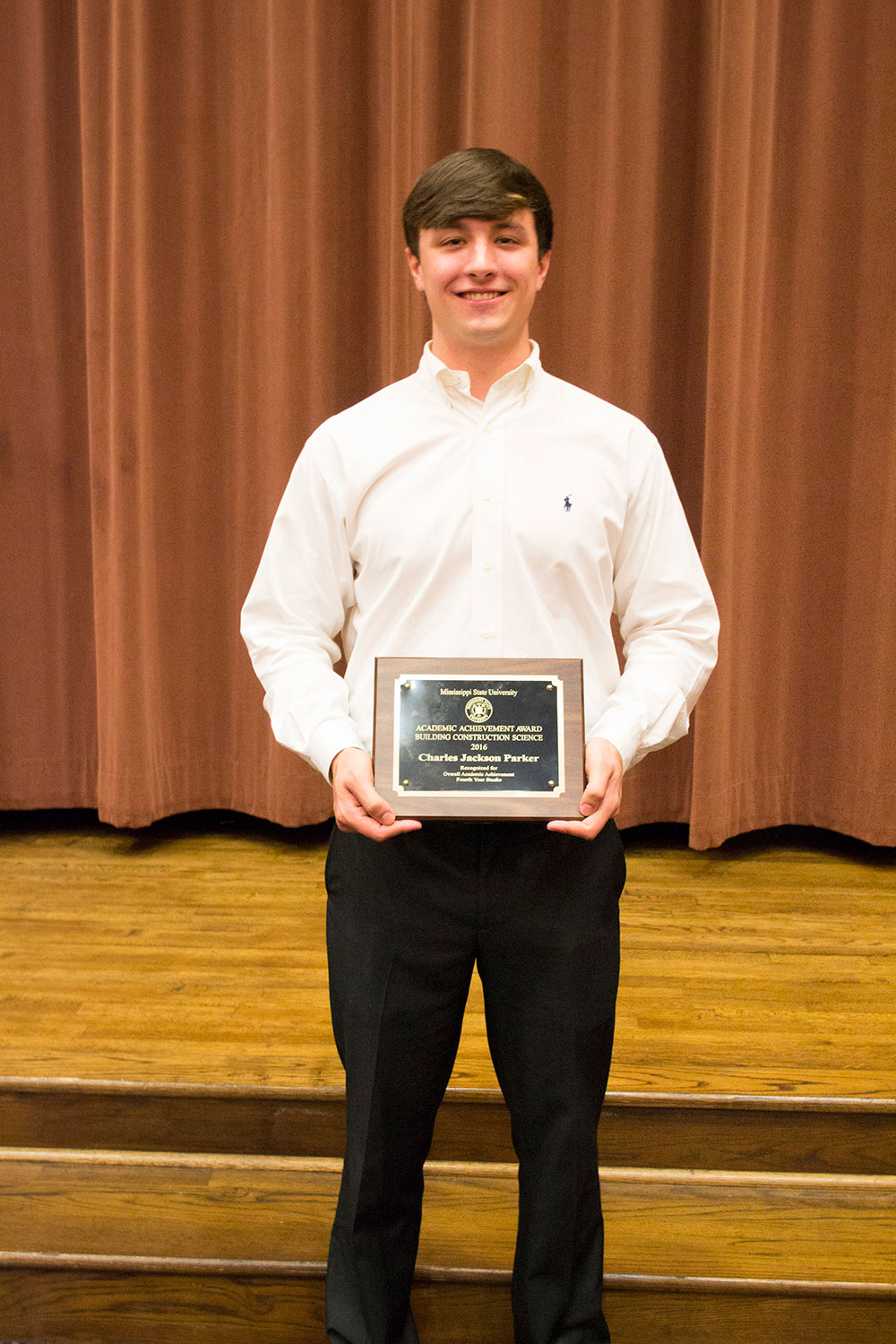 Jackson Parker holds award