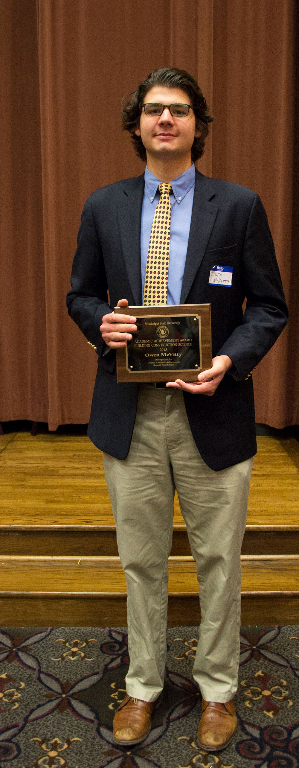 Owen McVitty holds award