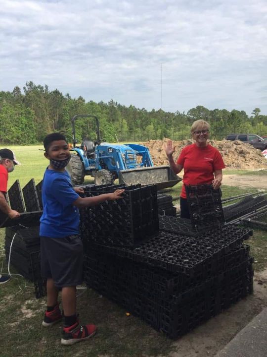 people stand by crates