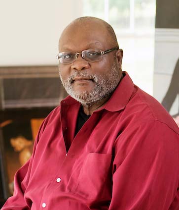 headshot of Bostic wearing red shirt