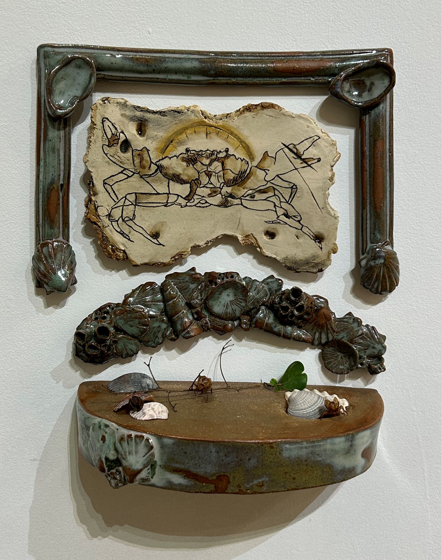 ceramic set with crab in sand-like setting with seashells