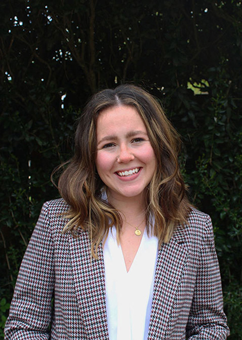 Caroline Harris headshot - outside with tree background