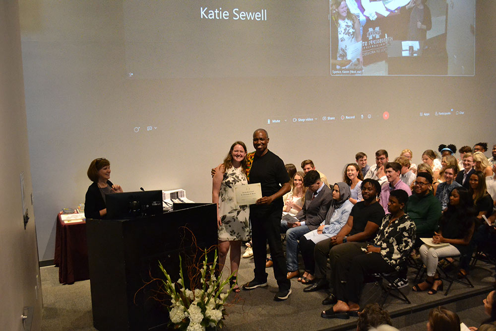 Professor Christopher Hunter, right, stands with Elaine Otts on stage