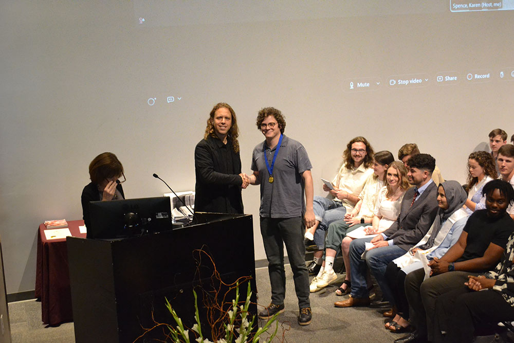 Luke Murray, right, shakes hands with Professor Duane McLemore