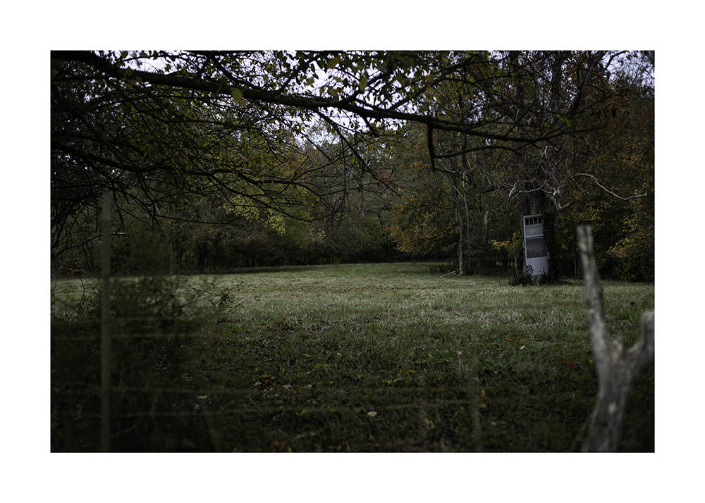 A door is photoshopped into a field.