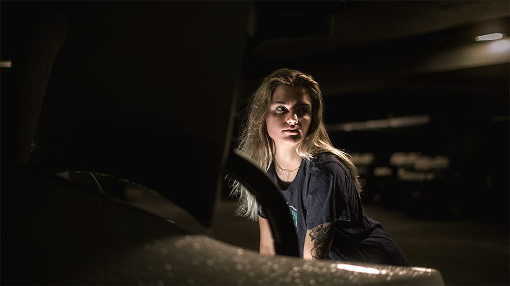 A photograph of a girl her face being lit up by light