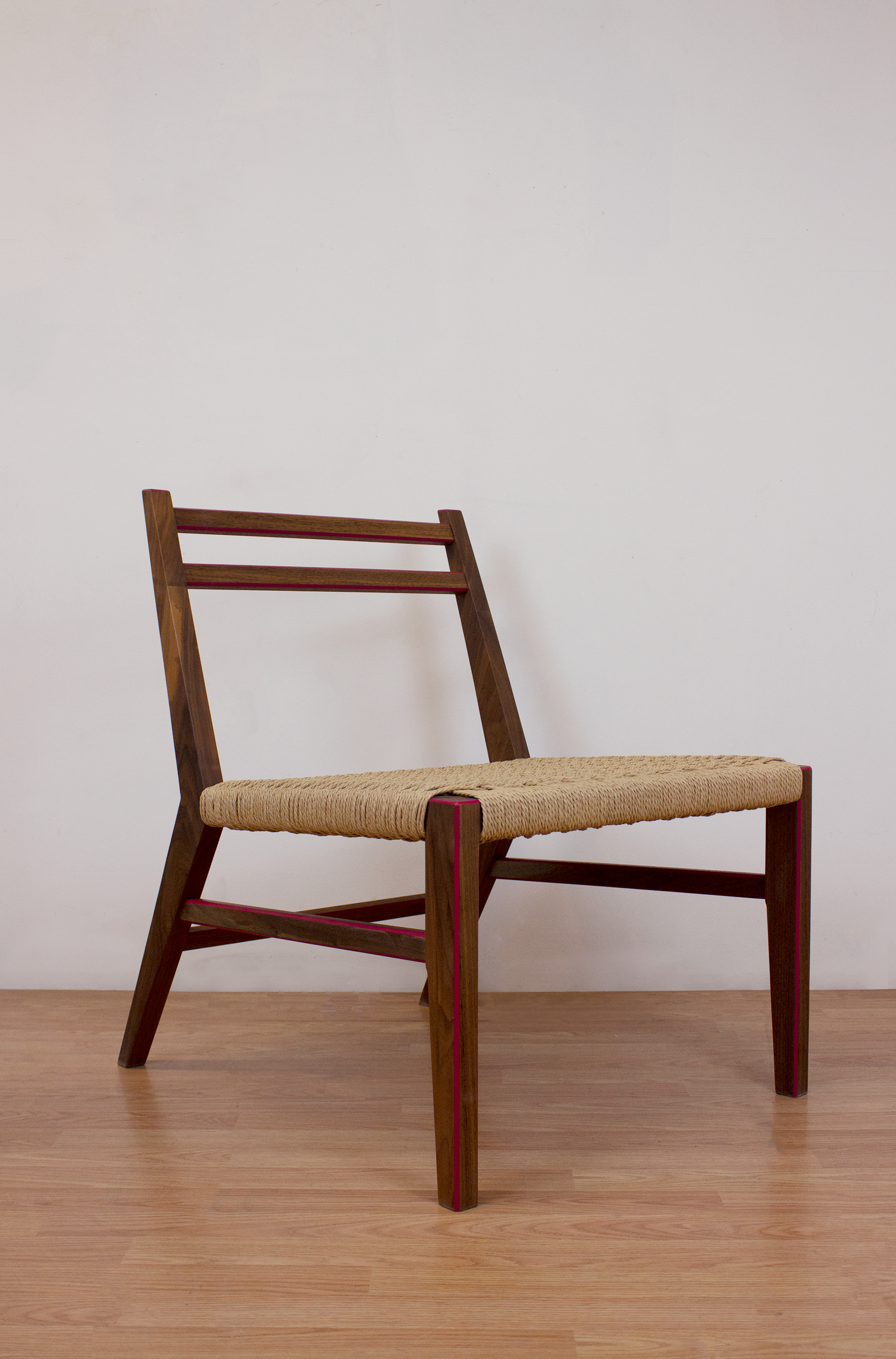 Lounge Walnut chair with woven Danish cord seat and pink highlights on the edges