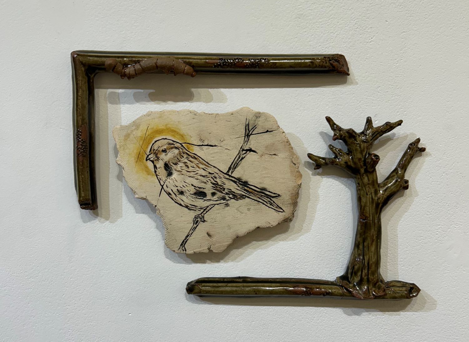 ceramic piece of bird with clay-made branches