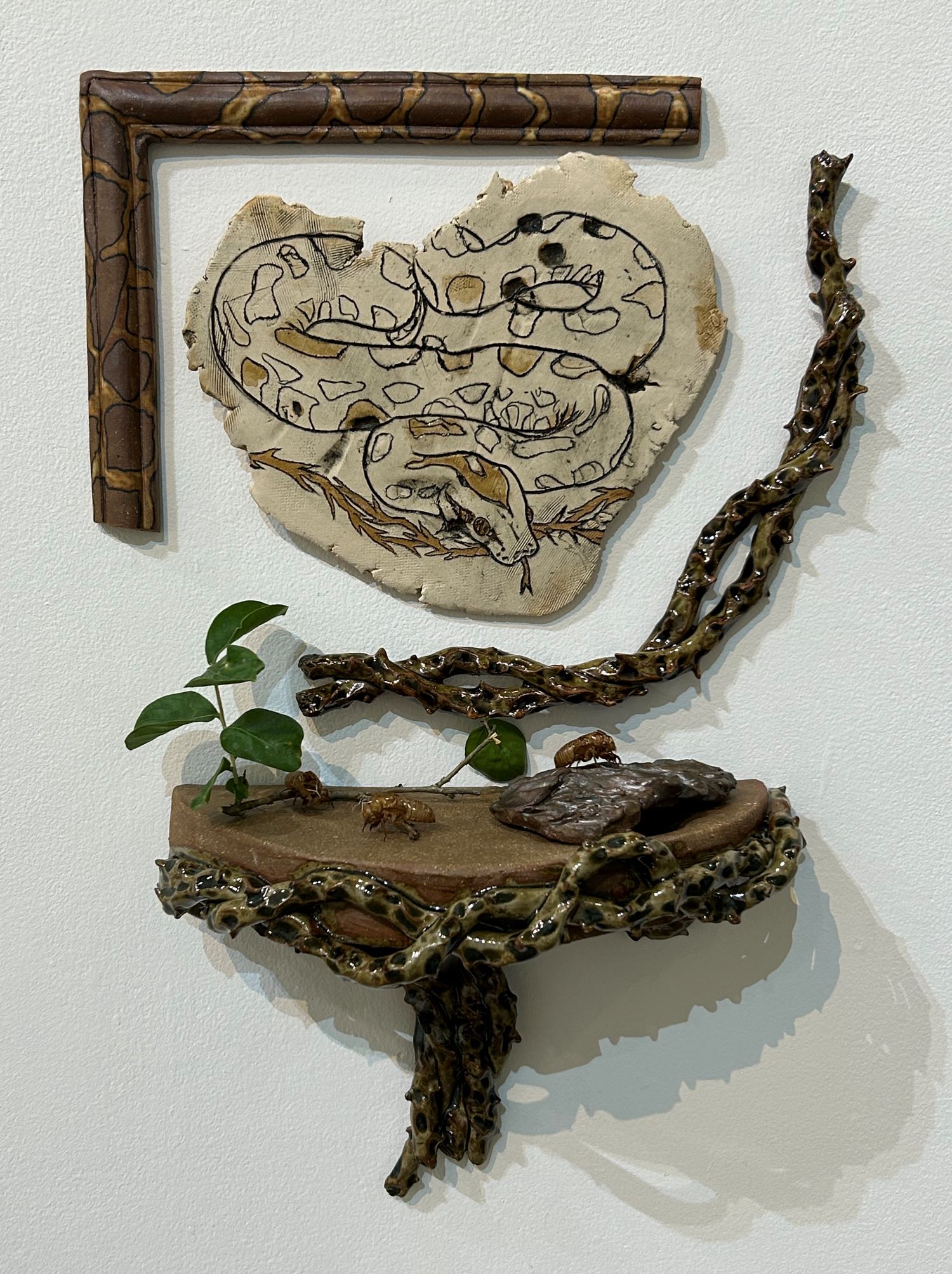 ceramic piece of a snake and branches