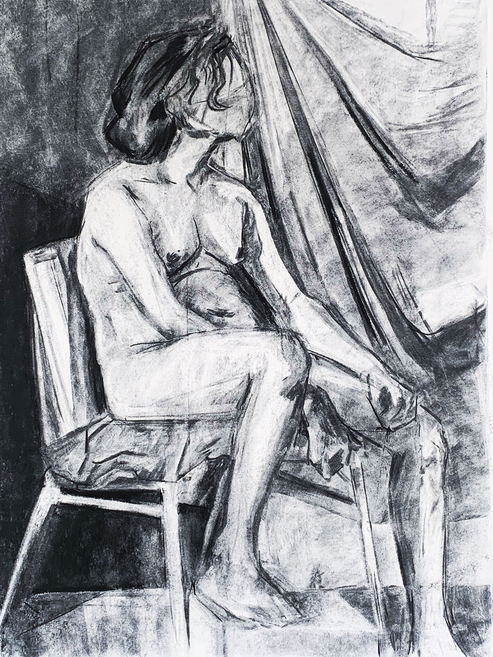 A charcoal drawing of a human model, using the reductive value technique to reveal light within the drawing. 