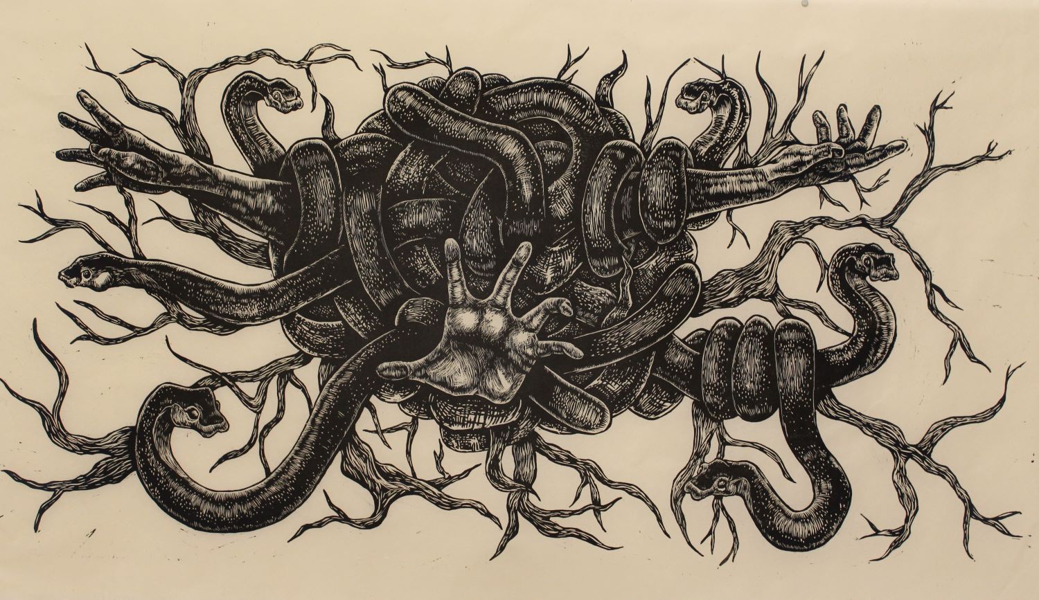 wood cut print of snakes and hands