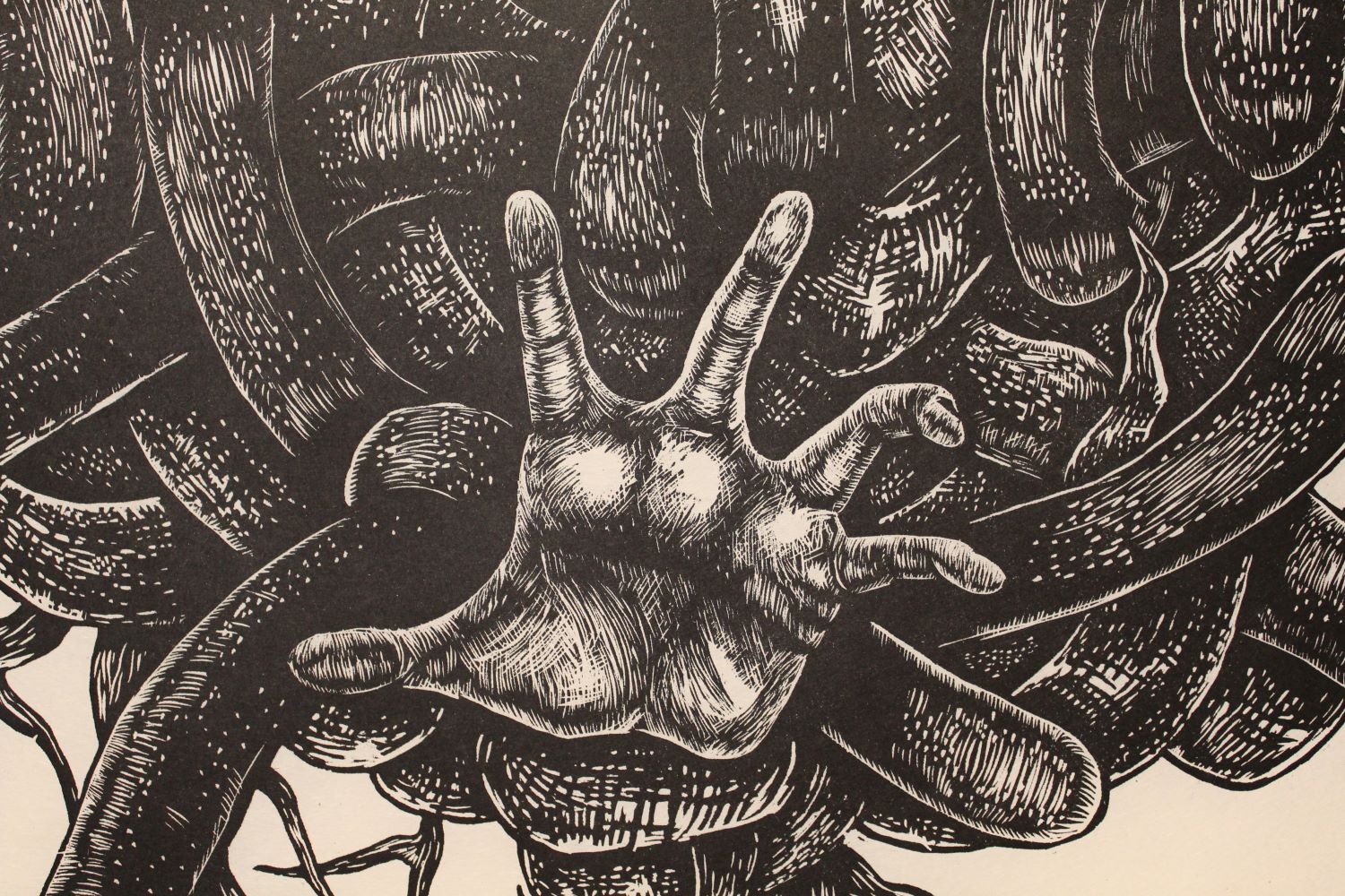 wood cut print of snakes and hands