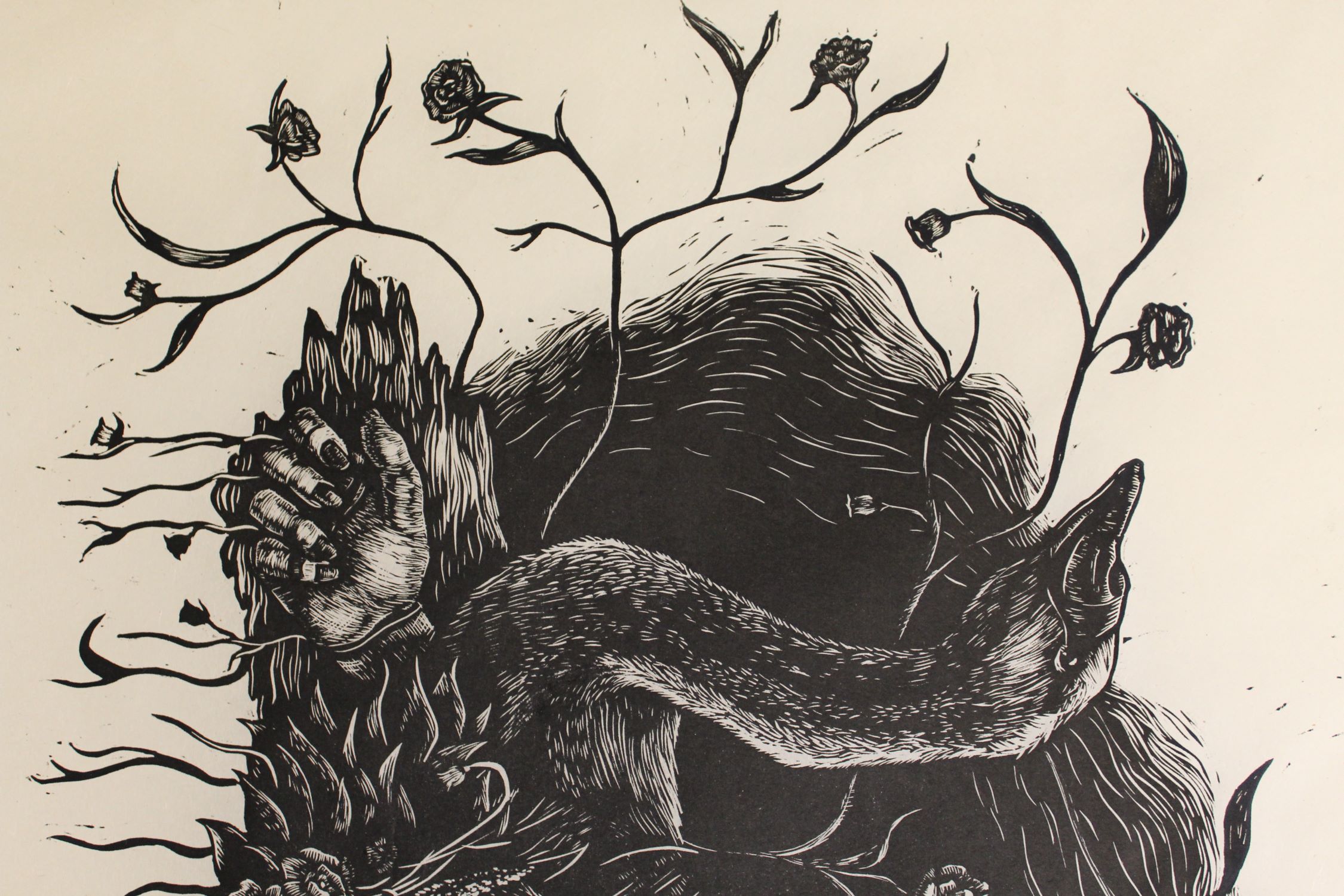 wood cut print of a swan head sitting on plants and a hand