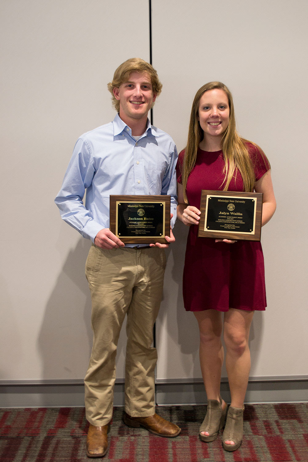 Jalyn Wallin (right) and Jackson Bates hold awards