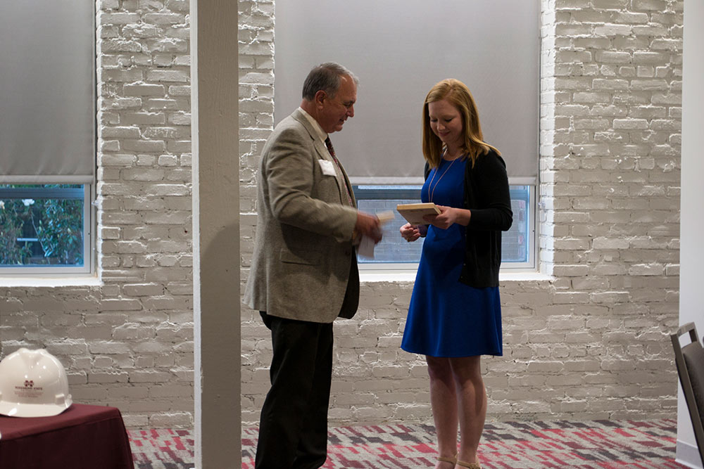 Regan Horn, right, accepts award from Tony Carroll