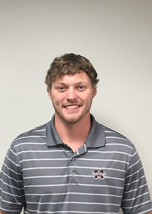 Jonathon Burton headshot in gray and white striped collared shirt against light wall