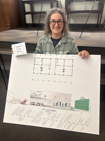 Charlyn King holds up her research poster. (Photo by Jennifer Burt, historic preservation graduate student)