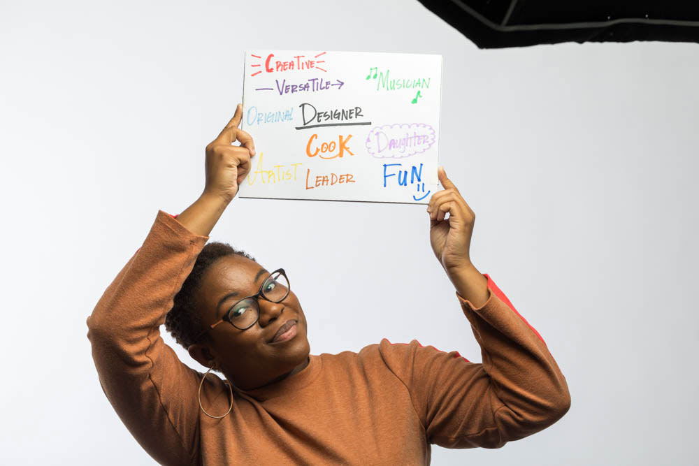 headshots of Jazmine Dennis holding up white board