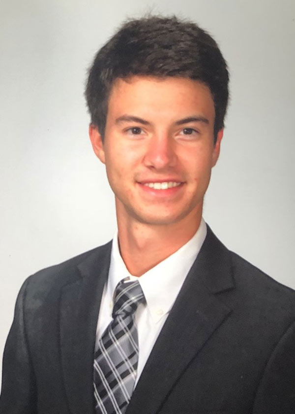 Robert Montoux headshot wearing suit and tie, light background