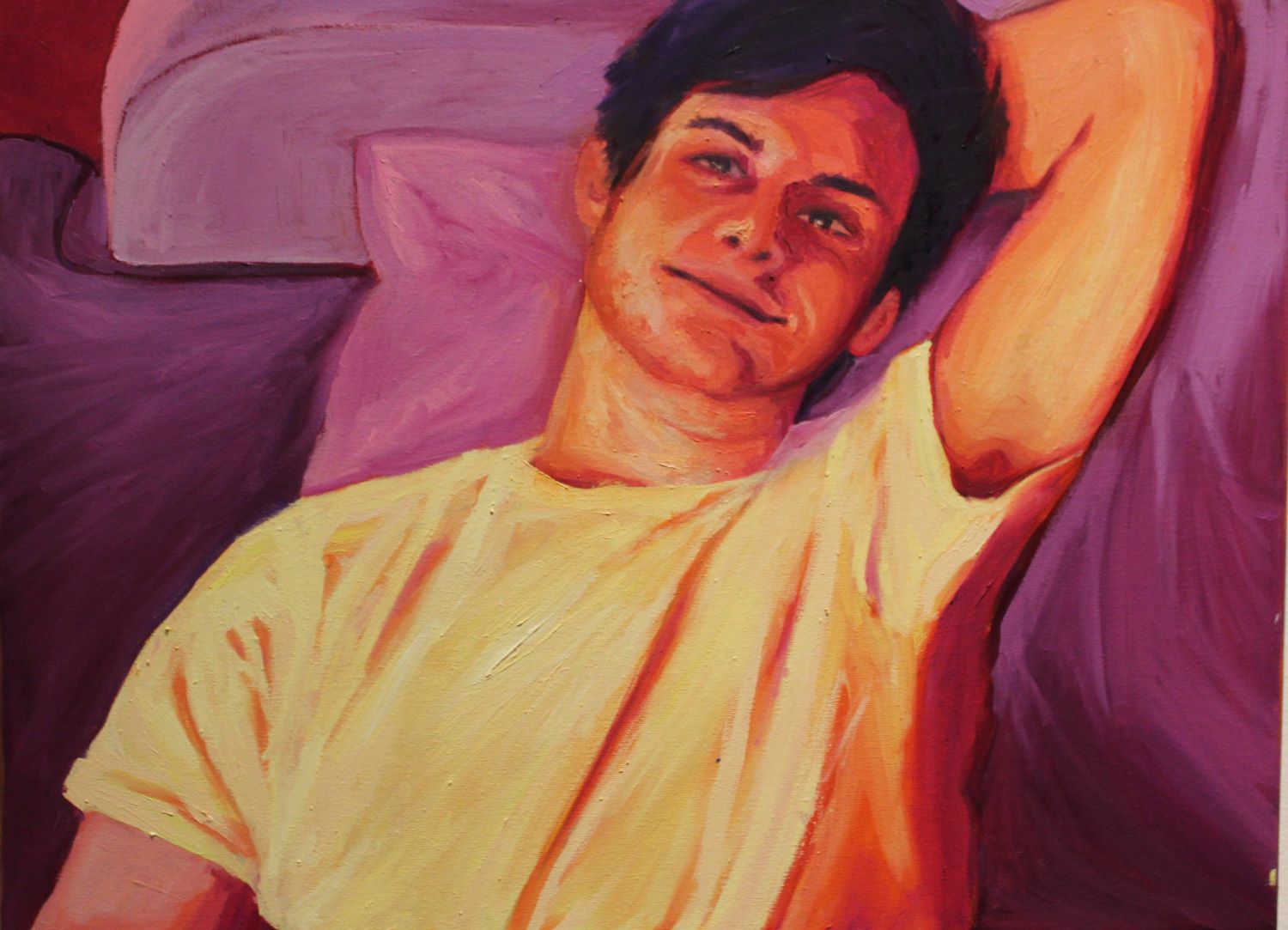 portrait of a man laying in bed