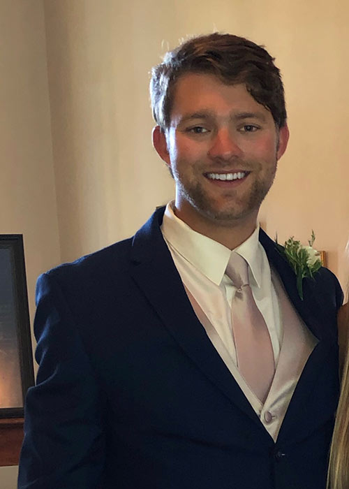 Mason Smith headshot wearing suit and tie