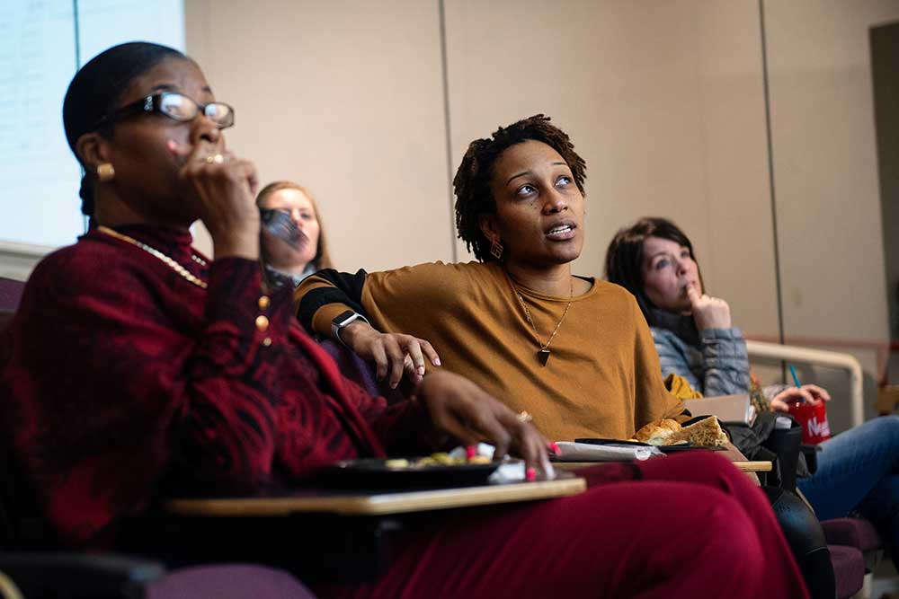 Nadia Colom, Boys and Girls Club of the Golden Triangle’s chief executive officer, listens to presentations by members of Mississippi State’s National Organization of Minority Architects student chapter. This semester, the architecture students have created design proposals for new Boys and Girls Club facilities in Starkville and West Point. (Photo by Megan Bean)