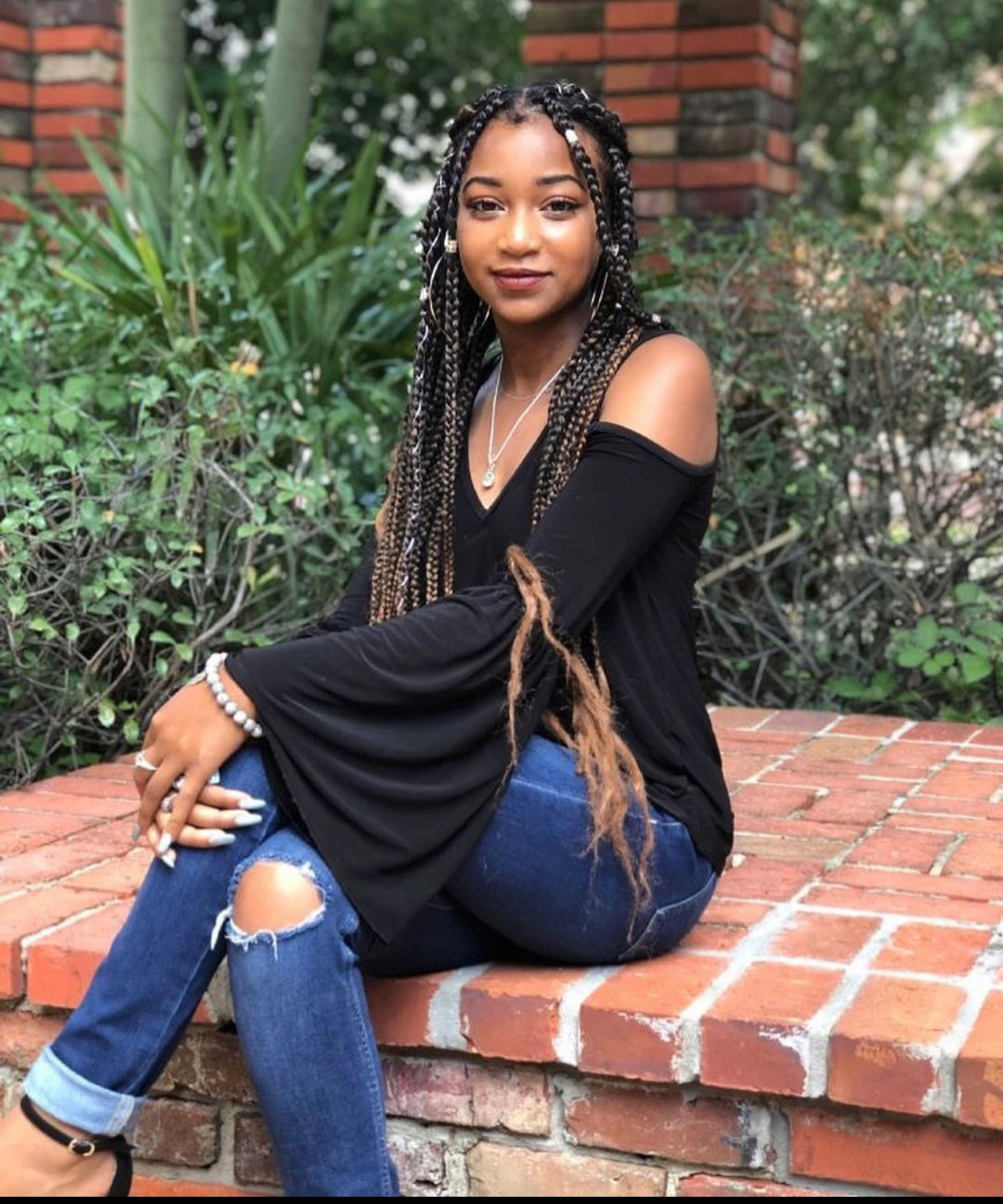 Alysia Williams sits on brick steps